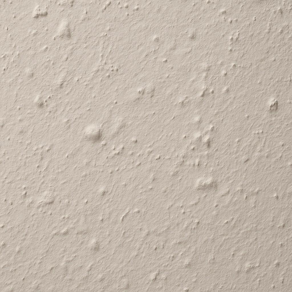 Close-up of a bumpy and uneven wall surface before repair